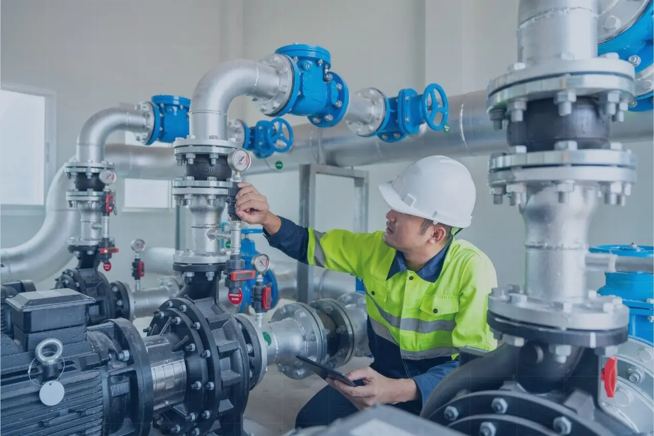 Trusted Data Is the Foundation of Modern Operations 4 Worker in a hard hat checking valves in a water pump room